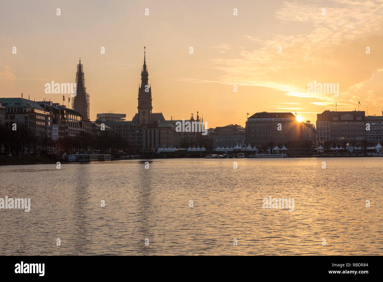 The artificial Inner Alster Lake frames the old buildings and palace of the city center at sunset Hamburg Germany Euope Stock Photo