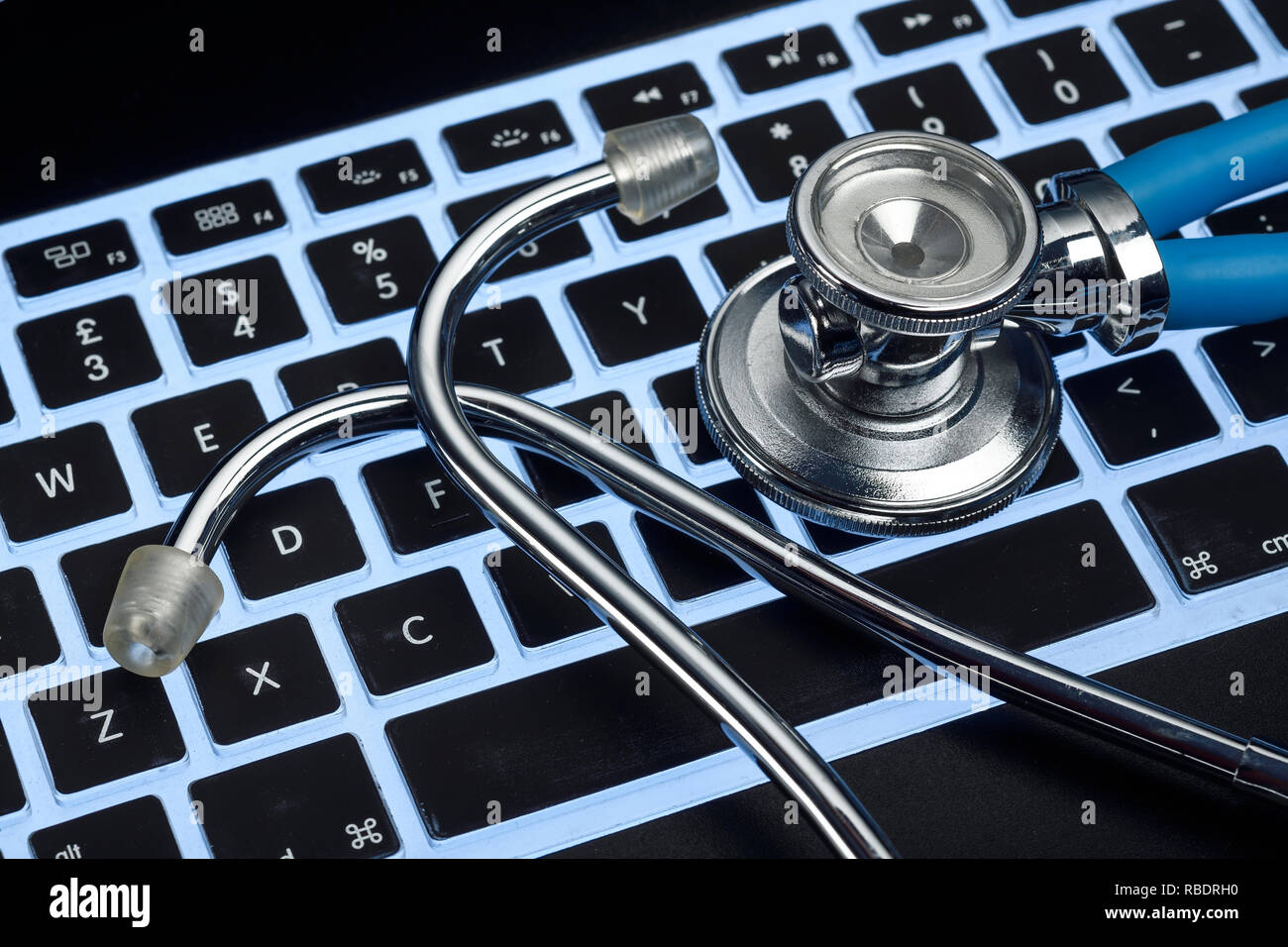 A computer keyboard with a stethoscope Stock Photo - Alamy