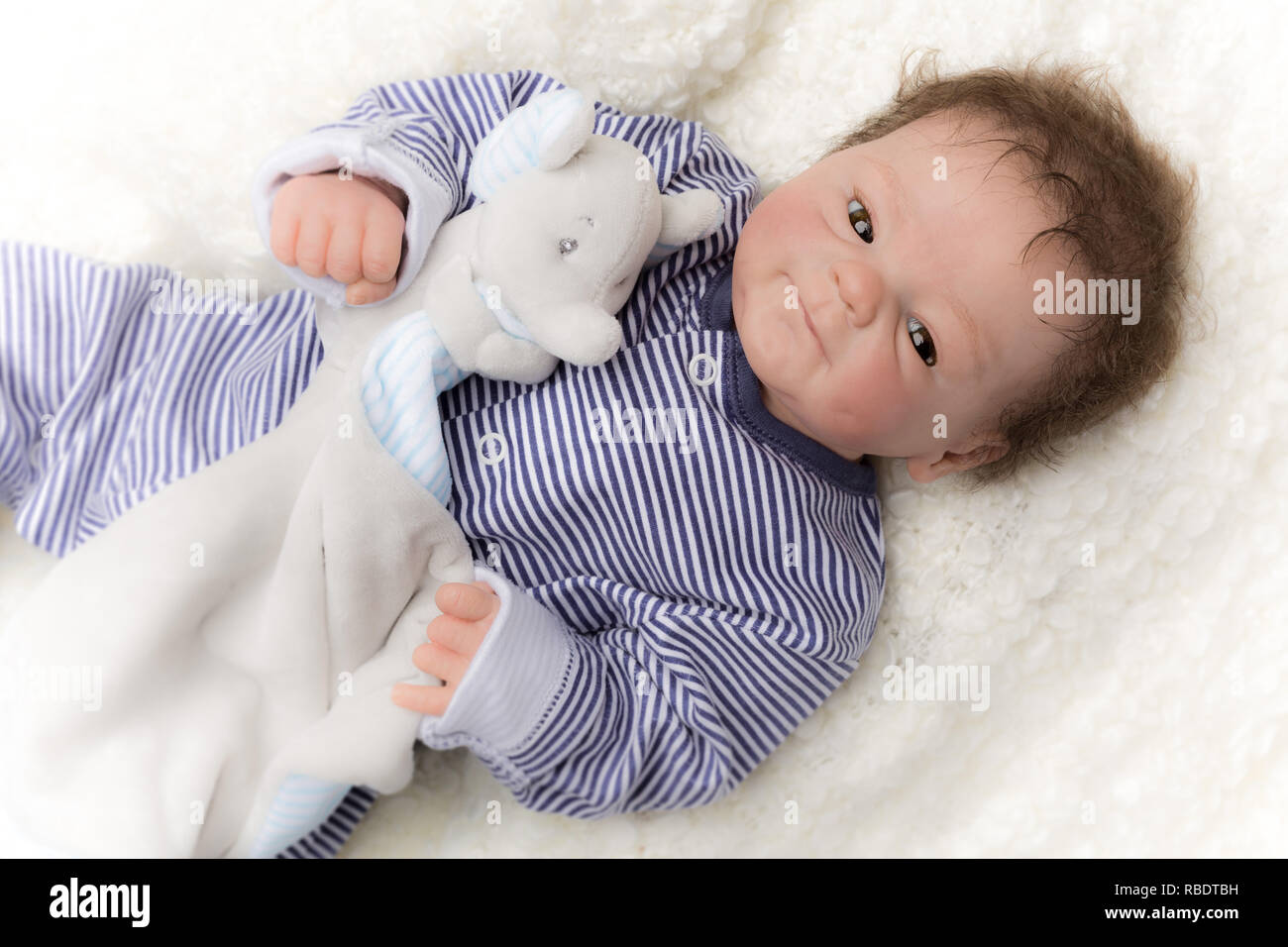 Reborn baby doll. Vinyl sculpt, Coco Malu by Eliza Marx. A reborn is an anatomically correct doll, hand painted to give the appearence of a real baby. Stock Photo