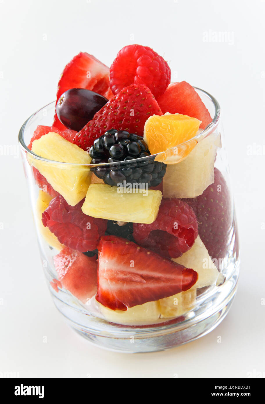 A Cup Of Assorted Fruit Ready To Eat On A White Background Including Strawberries Pineapple Orange Blackberries And Watermelon Stock Photo Alamy
