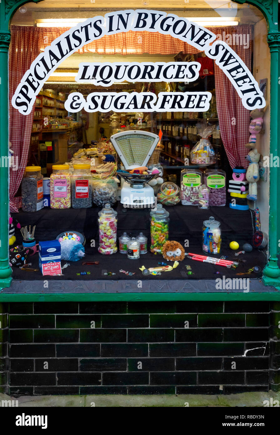 Small traditional sweet shop selling all kinds of old-fashioned sweets and candy in Thirsk Market Place North Yorkshire UK Stock Photo