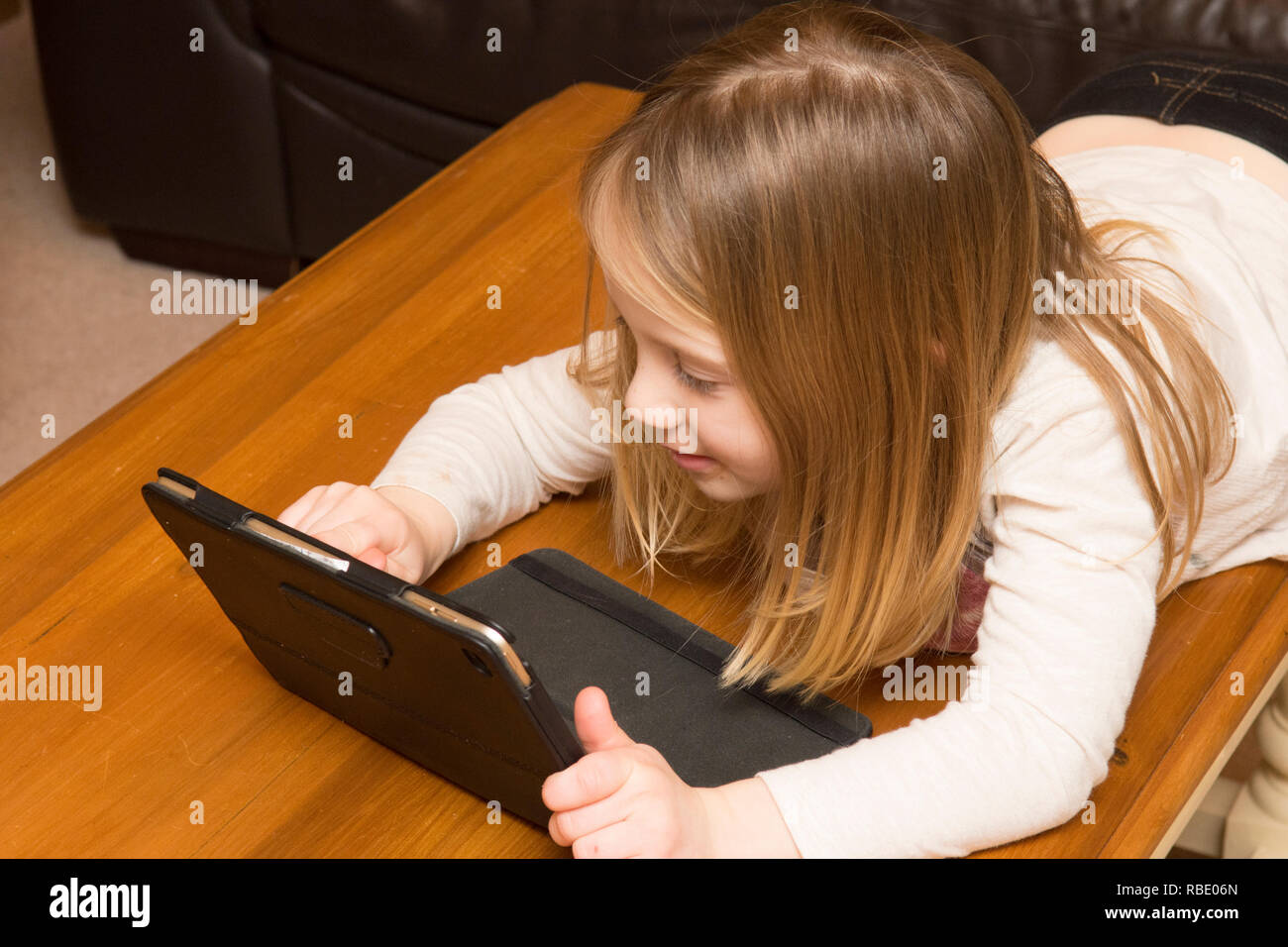 young girl playing with a tablet, digital device, iPad, screen, Three years old child Stock Photo