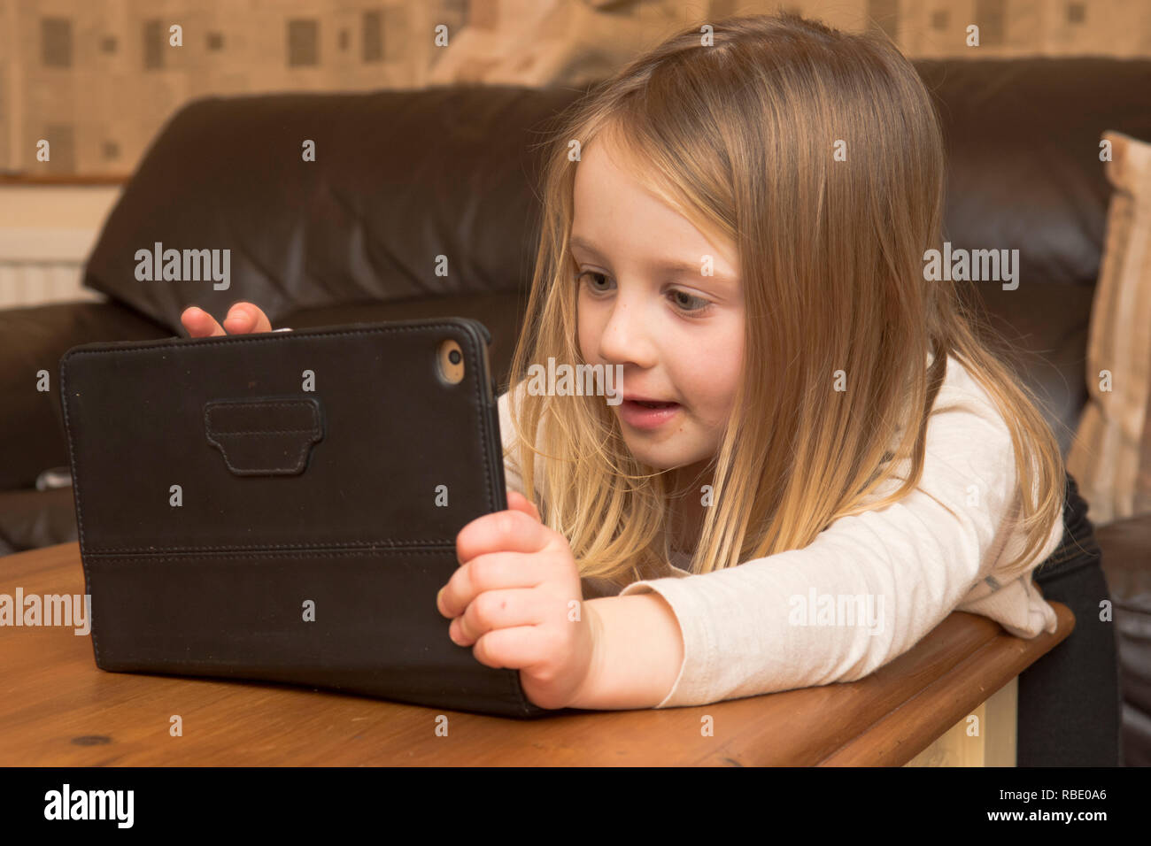 young girl playing with a tablet, digital device, iPad, screen, Three