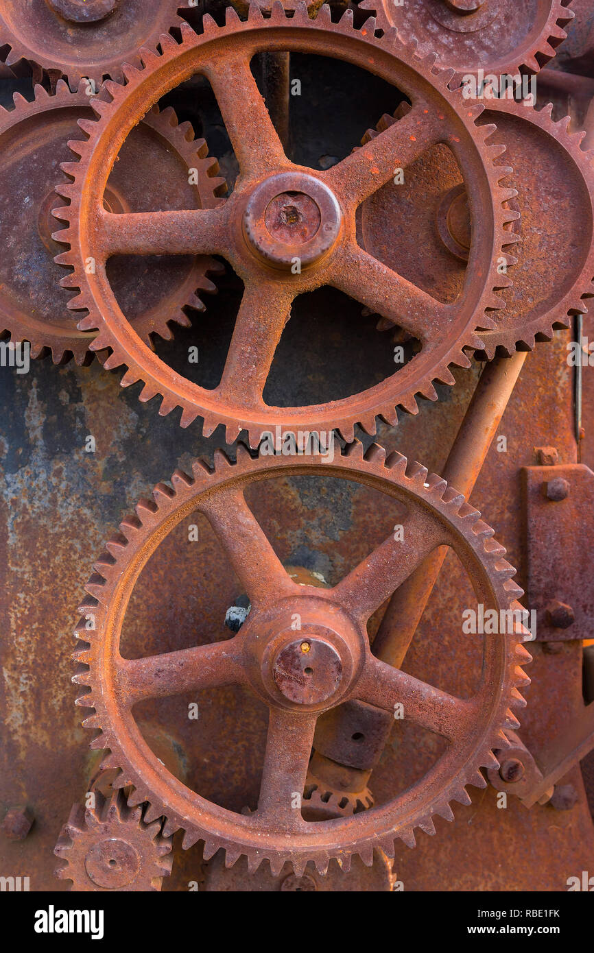 Rusty gears of old farm equipment machinery metal grunge texture background Stock Photo