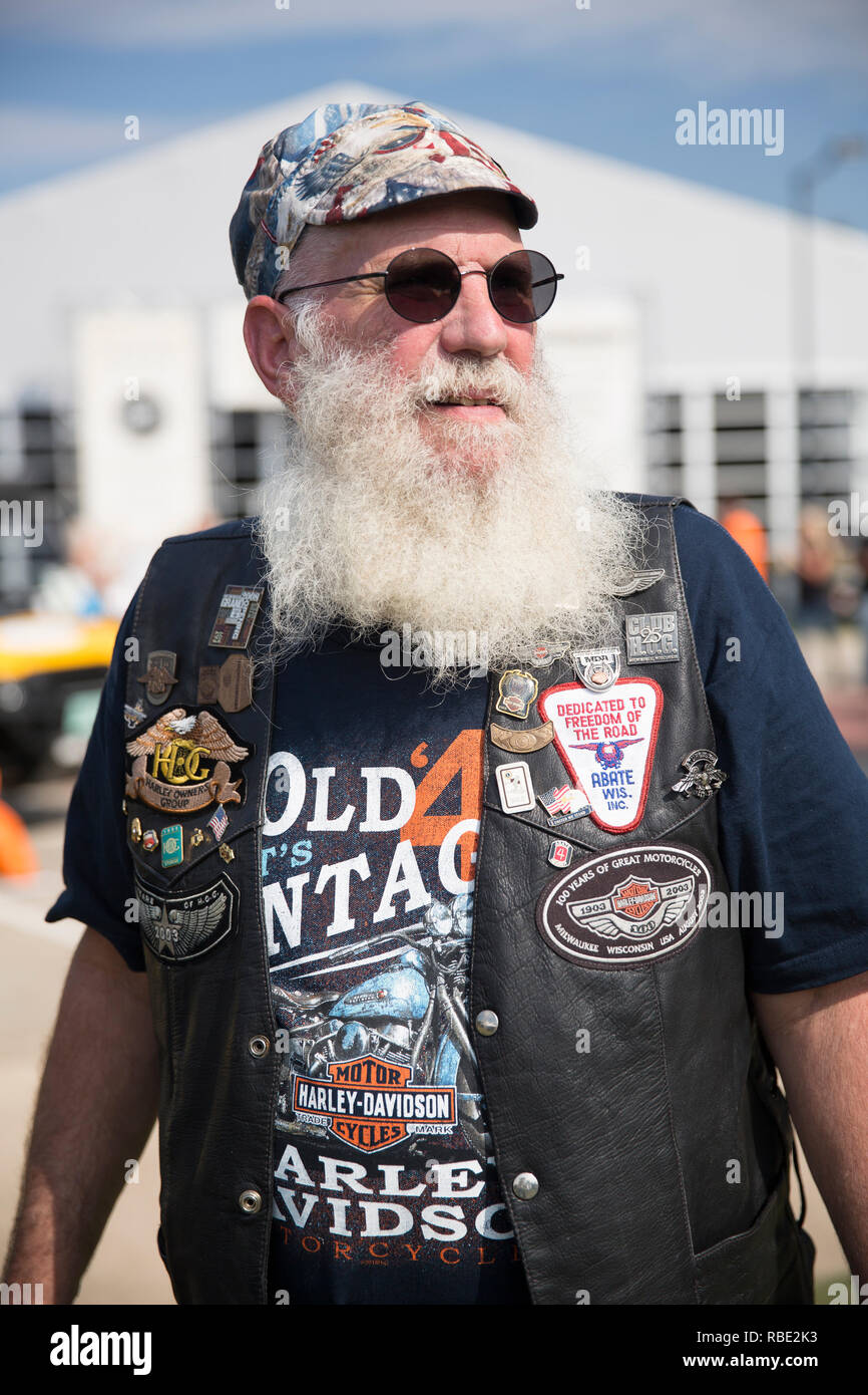 A older grey bearded motorcyclist attends the 115th Harley-Davidson anniversary event at the Harley-Davidson Museum in Milwaukee, Wisconsin Stock Photo