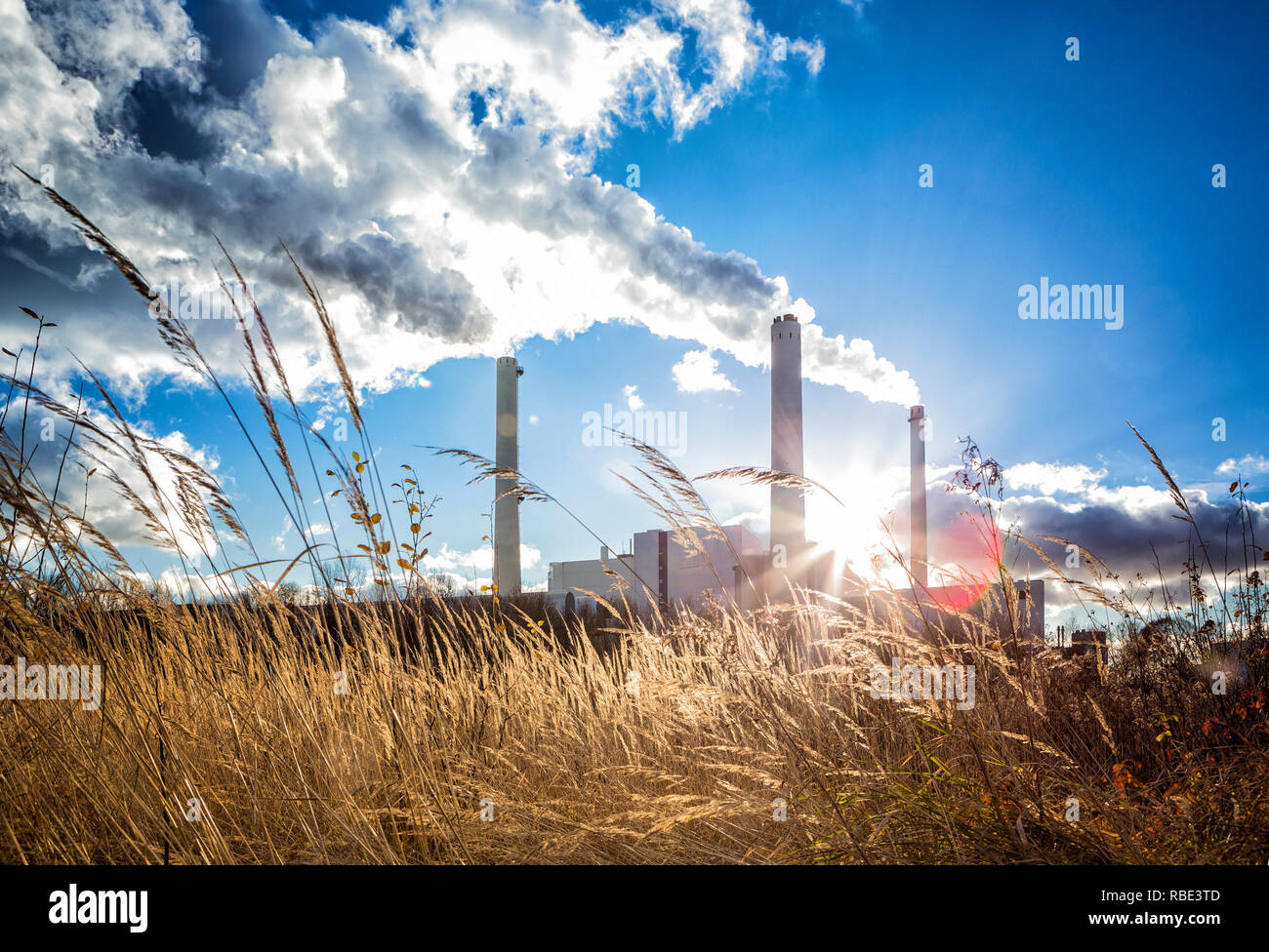 Combined Heat And Power Plant Against The Sun 3 Funnels With Smoke Coming Out Weed In The 