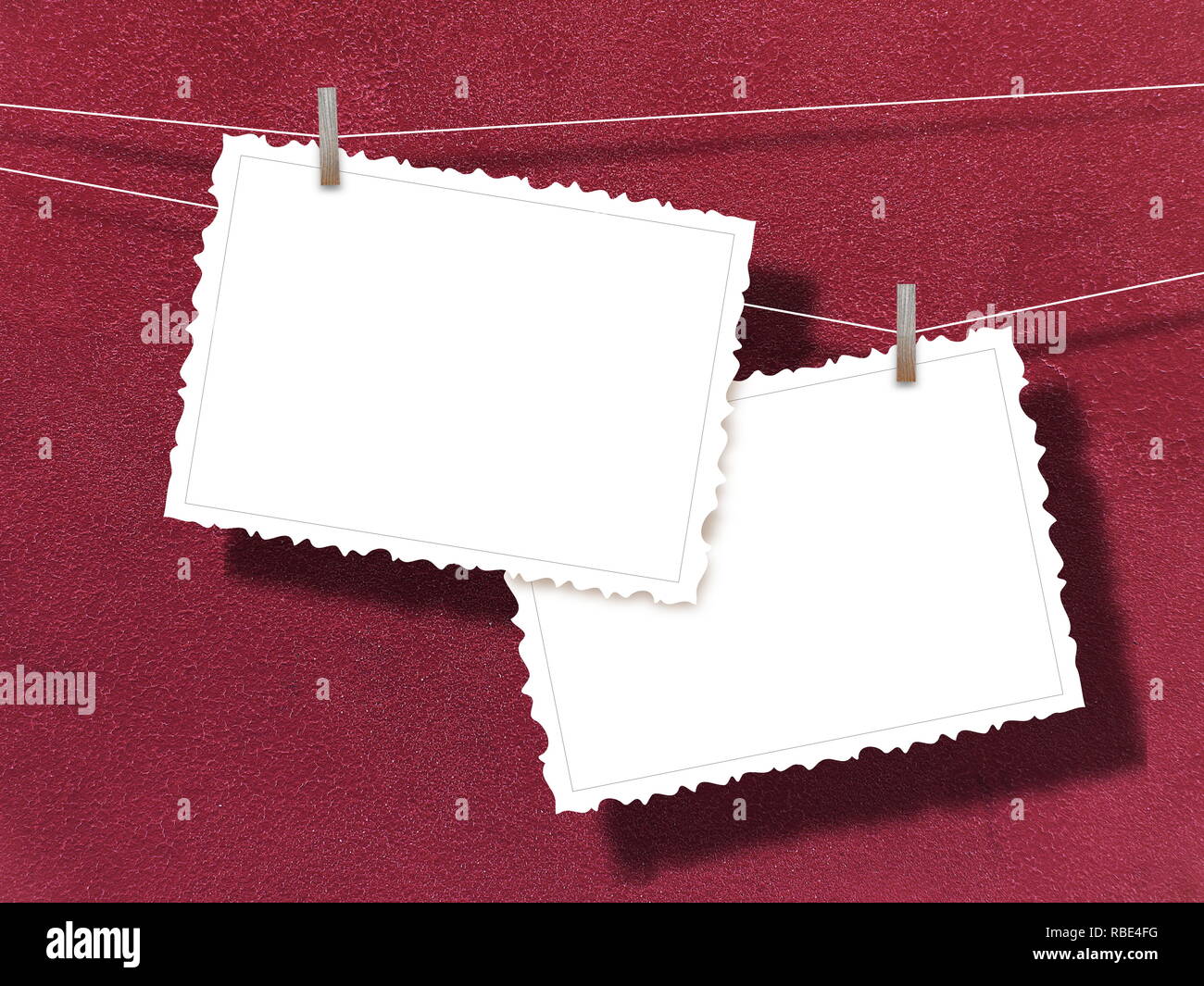 Two blank postcard frames against red plaster wall Stock Photo