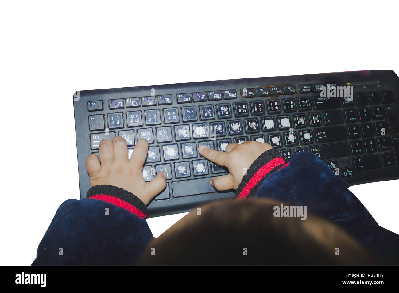small boy typing computer keyboard with isolated or white background with clipping path Stock Photo