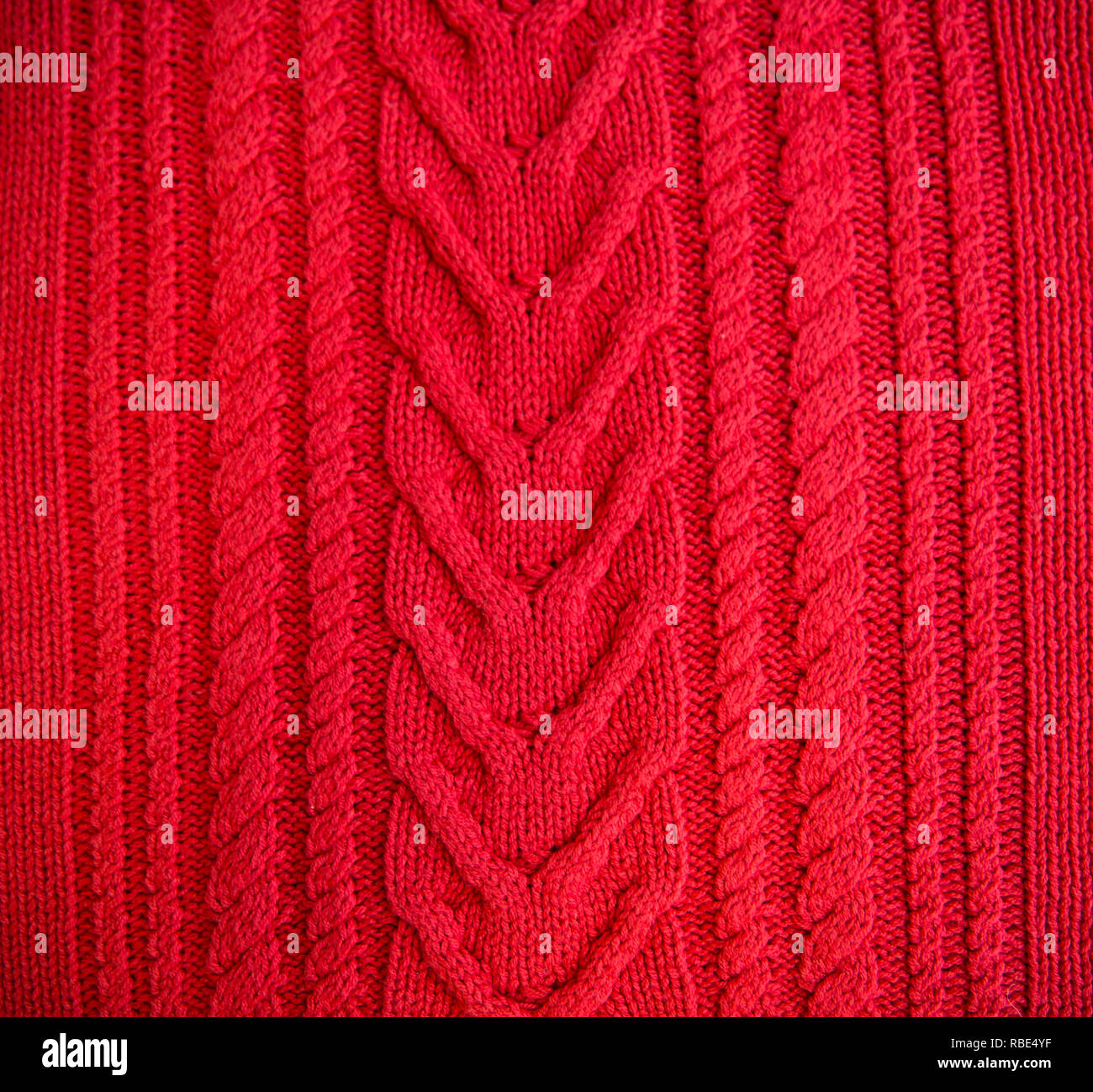 Red Knitted pattern wool sweater texture close up. Handmade red ...