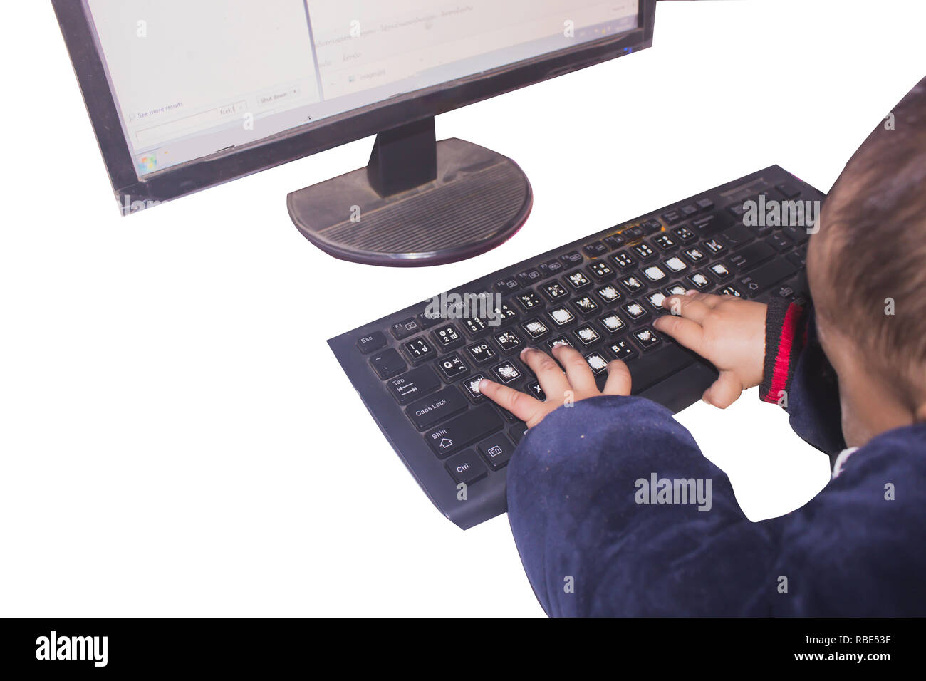 small boy typing computer keyboard with isolated or white background with clipping path Stock Photo