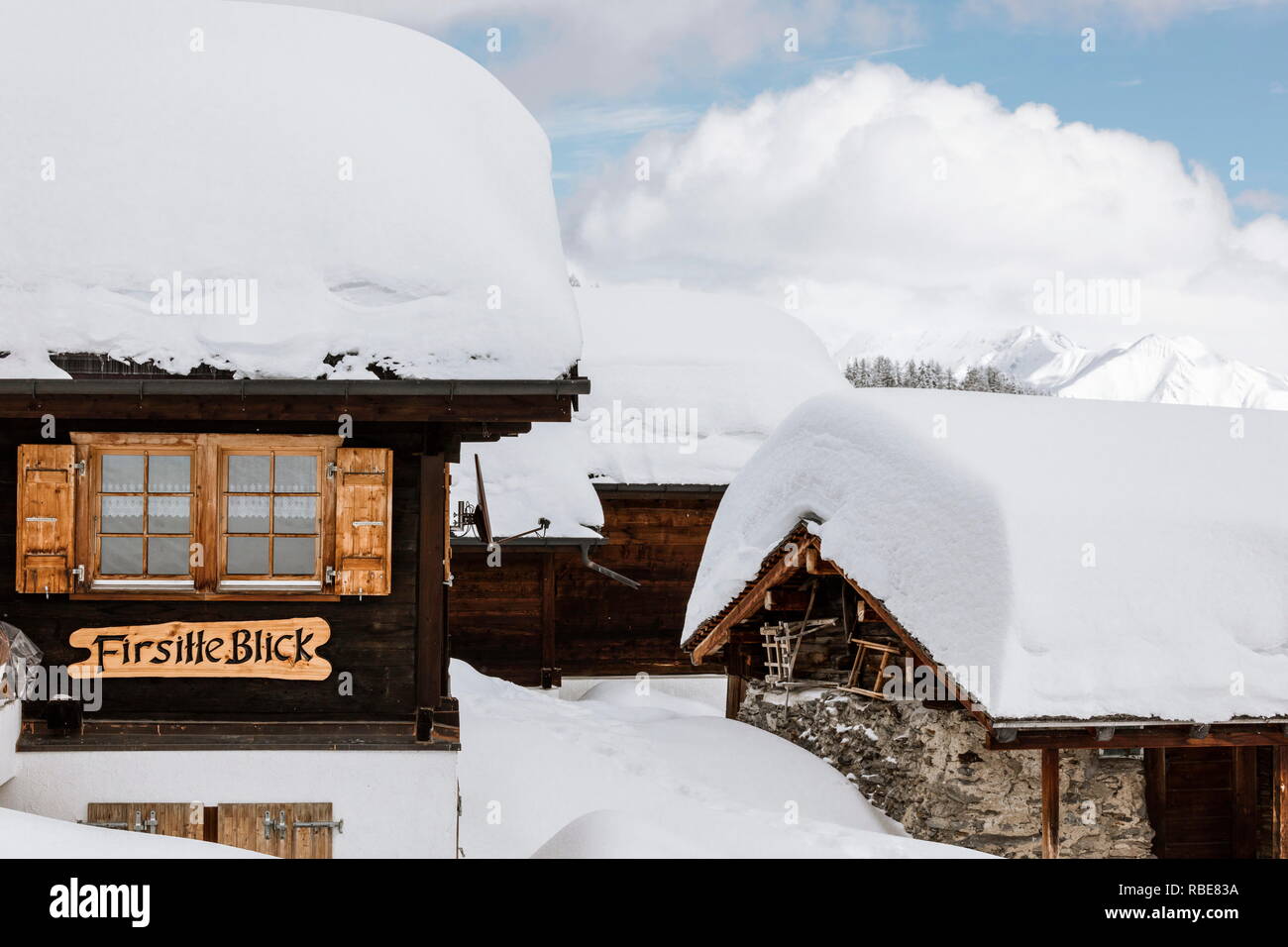 Typical mountain huts submerged by fresh snow Bettmeralp district of Raron canton of Valais Switzerland Europe Stock Photo