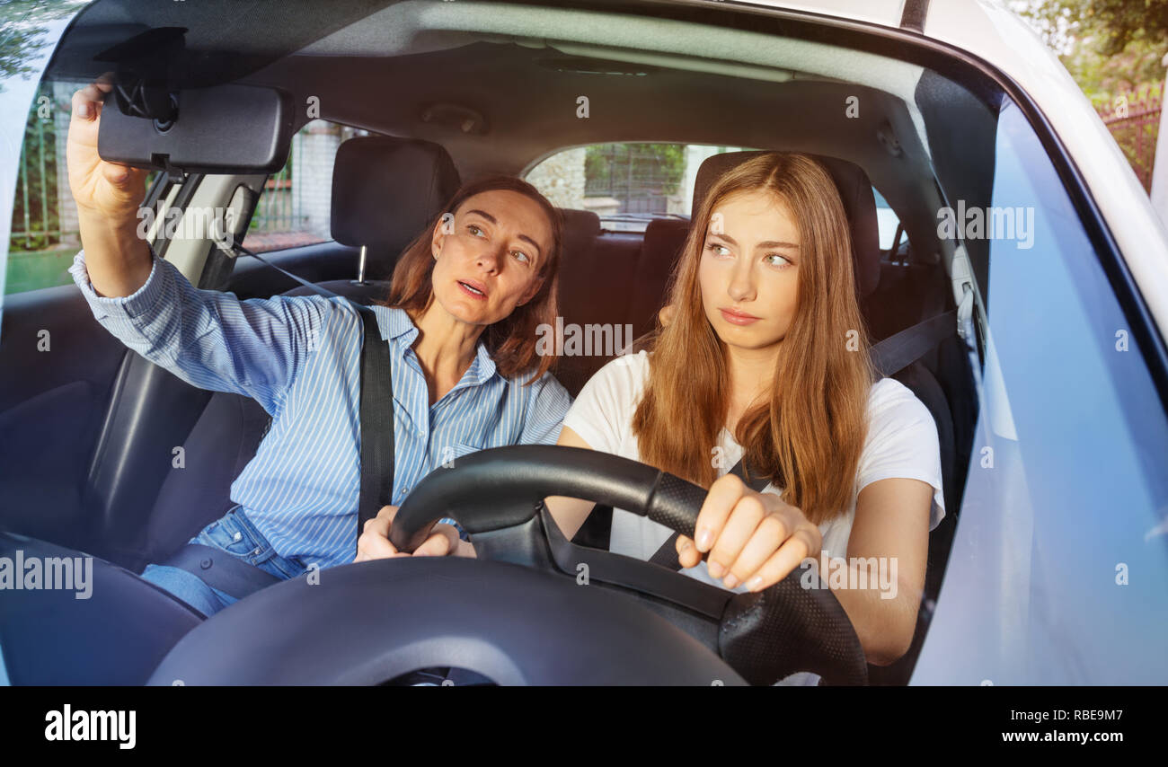 Girl and her mother during driving lesson in a car Stock Photo