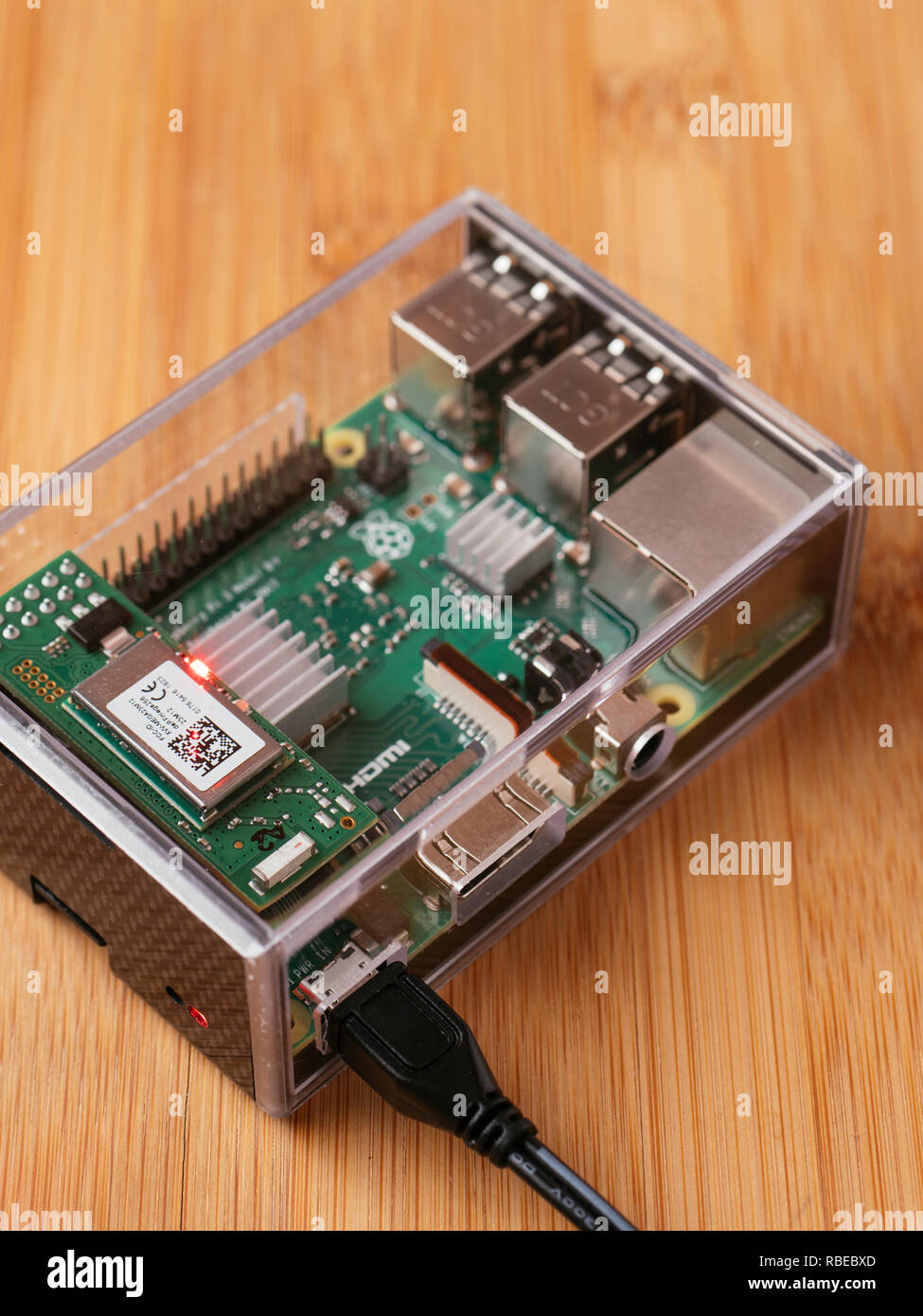 Raspberry Pi 3 Model B+ with ZigBee add-on board in a transparent case. Stock Photo