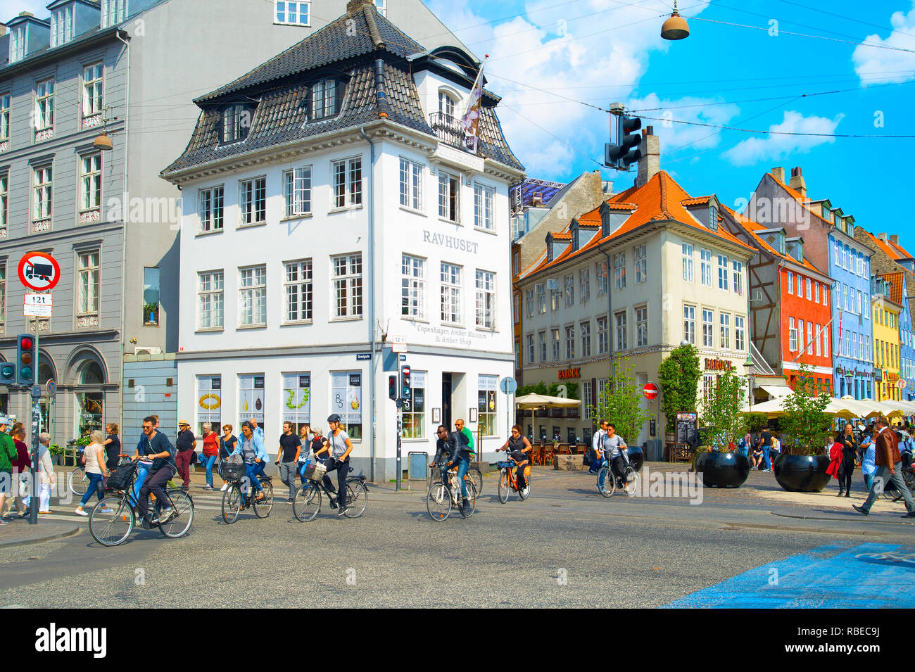 COPENHAGEN, DENMARK - JUNE 14, 2018: People walking and cycling at Copenhagen Old Town street. Copenhagen is the capital of Denmark Stock Photo