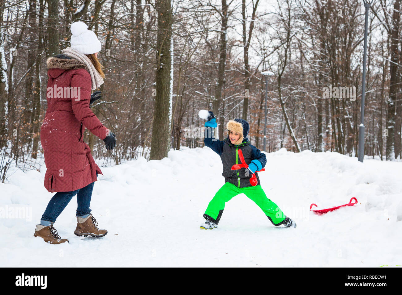 Winter family playing snowballs outdoor Stock Photo - Alamy