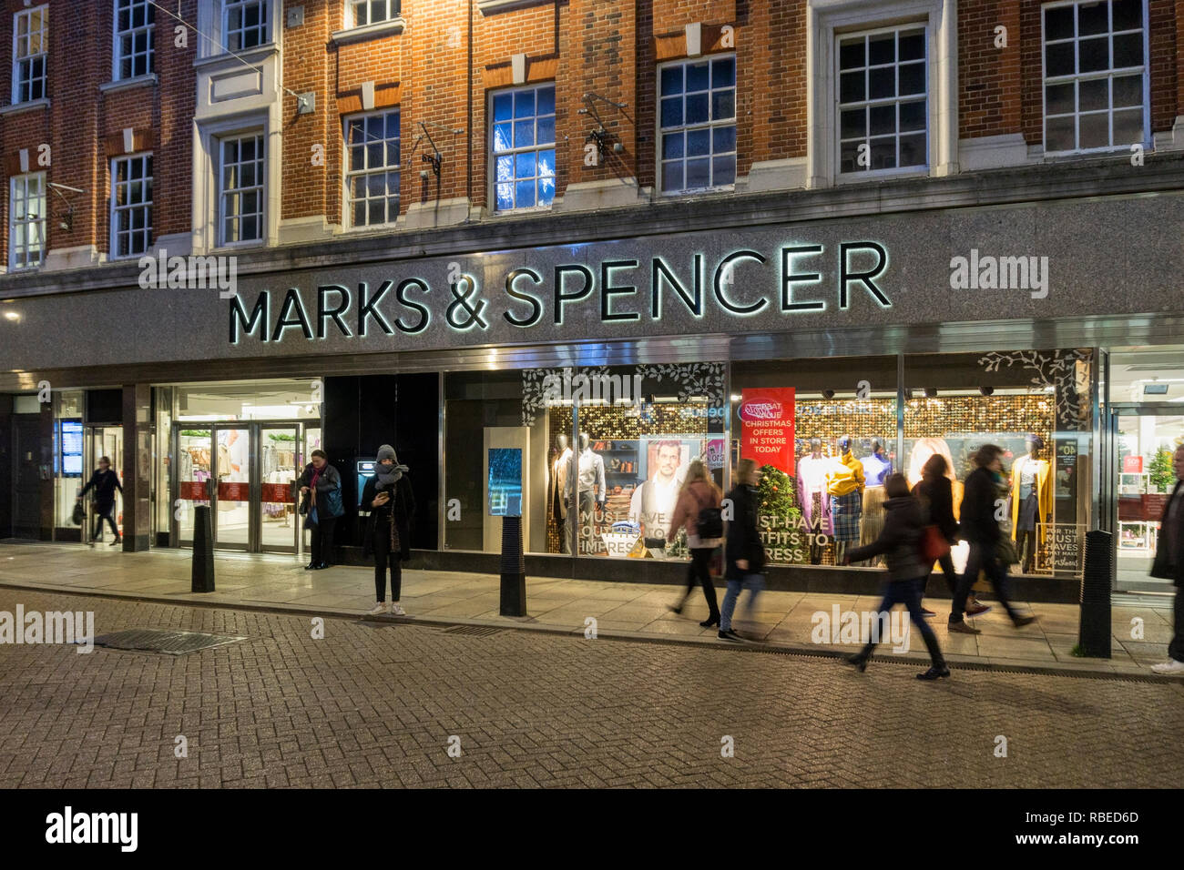 A branch of Marks & Spencer at dusk in Sidney Street, Cambridge. Stock Photo