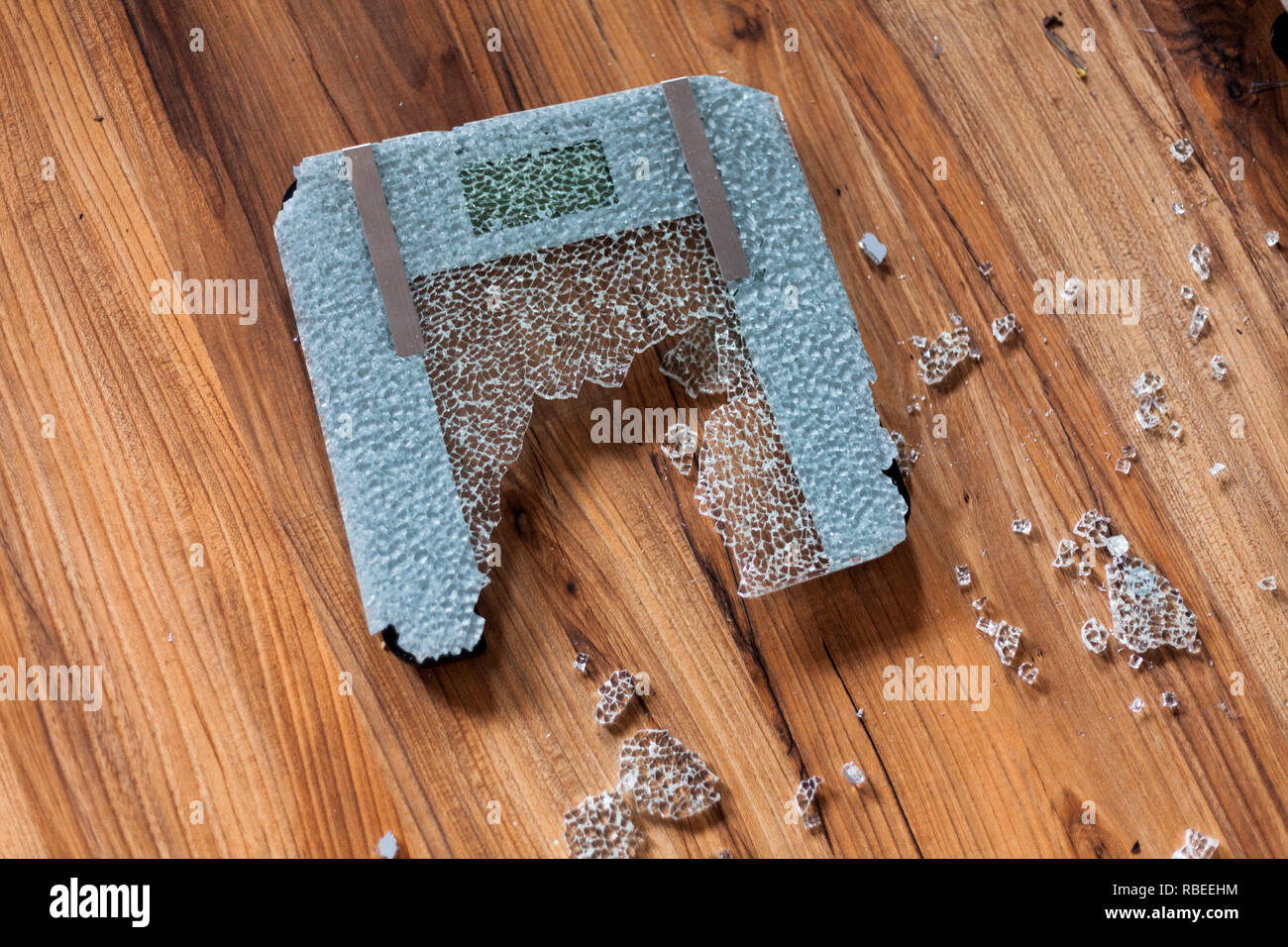 Broken digital human scale on the floor. Broken glassy digital scale