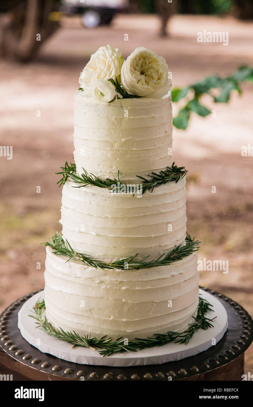 elegant and simple wedding cake with flowers on top Stock Photo