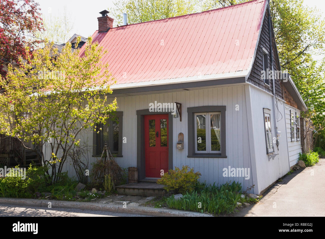 Old 1862 White With Red And Grey Trim Cottage Style Home Facade In