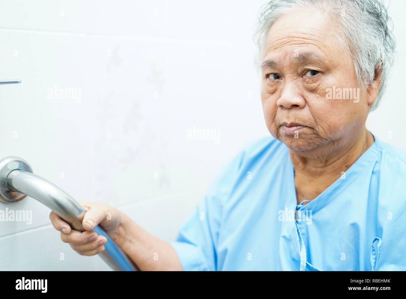 Asian senior or elderly old lady woman patient use toilet handle security in nursing hospital. Stock Photo