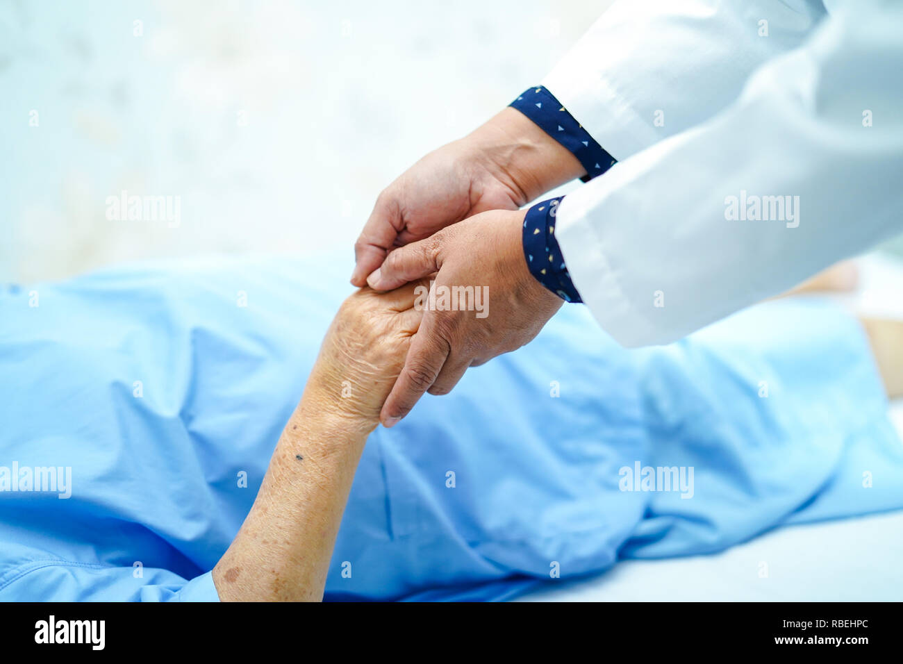 Holding hand Asian senior or elderly old lady patient with love, care, encourage and empathy. Stock Photo