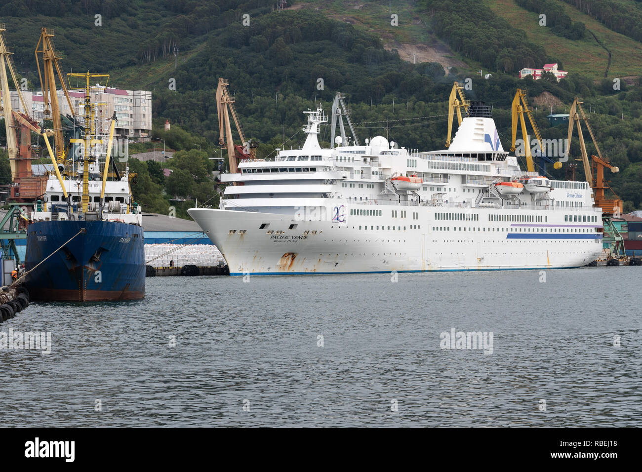 Summer view of Commercial Seaport of Petropavlovsk-Kamchatsky City - Russian fishing vessel Pamir and Japanese cruise liner Pacific Venus Stock Photo