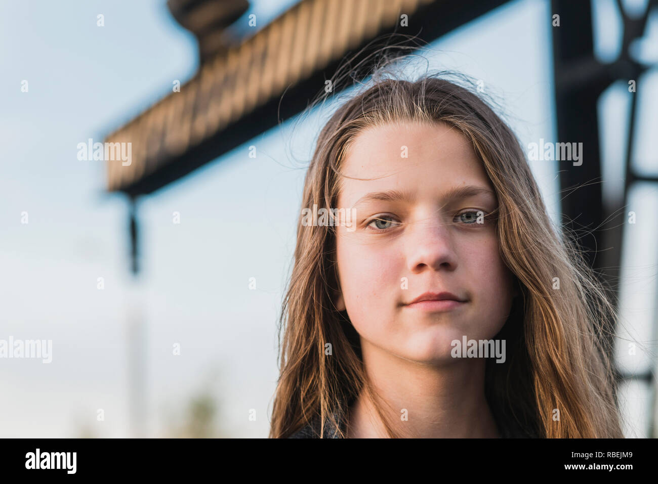 serious teenage girl face portrait at windy air outdoors by evening Stock Photo