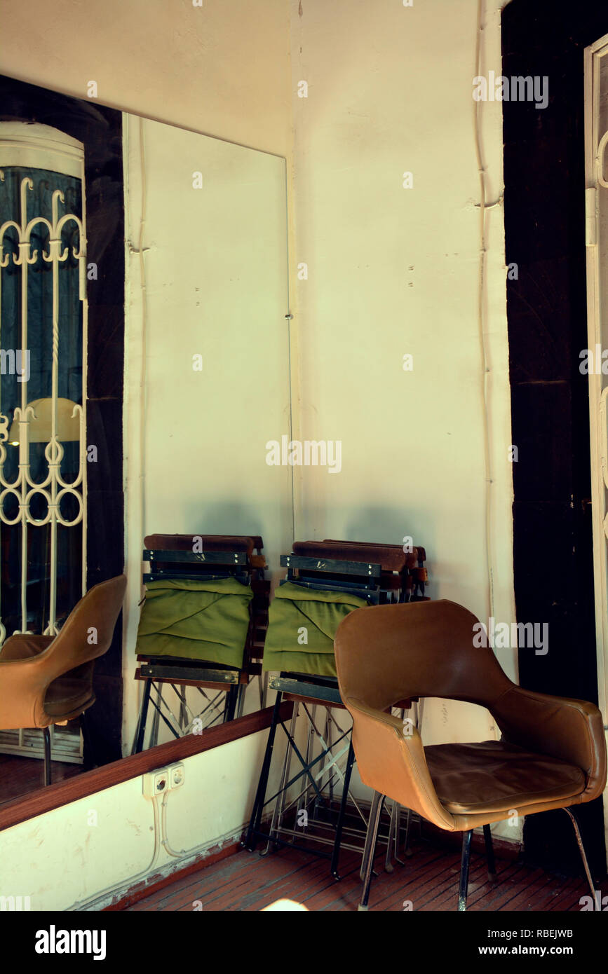Old fashioned armchair on wooden floor Stock Photo - Alamy