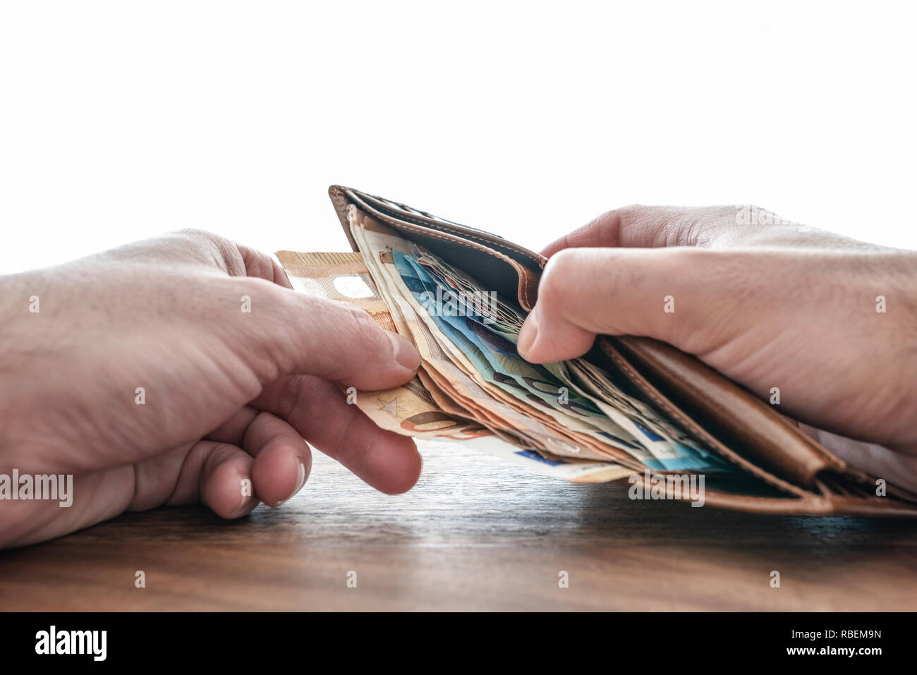 hands taking paper money out of wallet Stock Photo