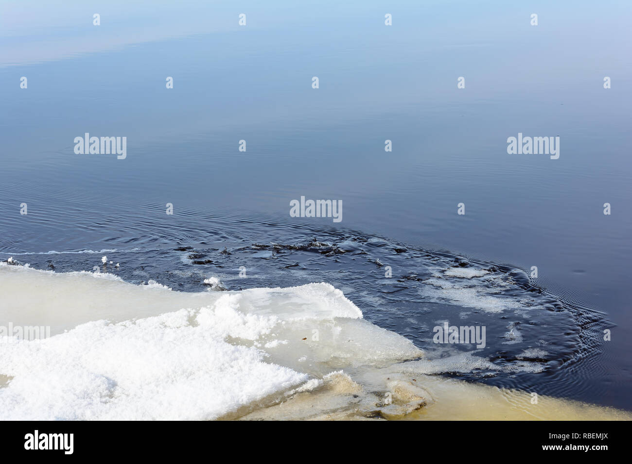 Melting of ice on the river in early spring under the warm rays of the sun Stock Photo