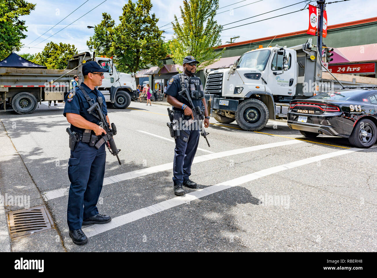 Vancouver Police barricade street with dump trucks and carry automatic