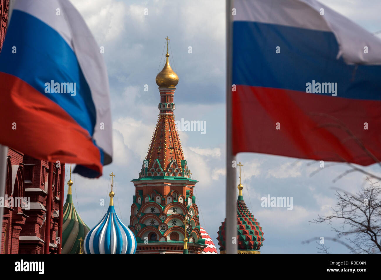 Russian national flag on background of the Saint Basil Cathedral in Moscow, Russia Stock Photo