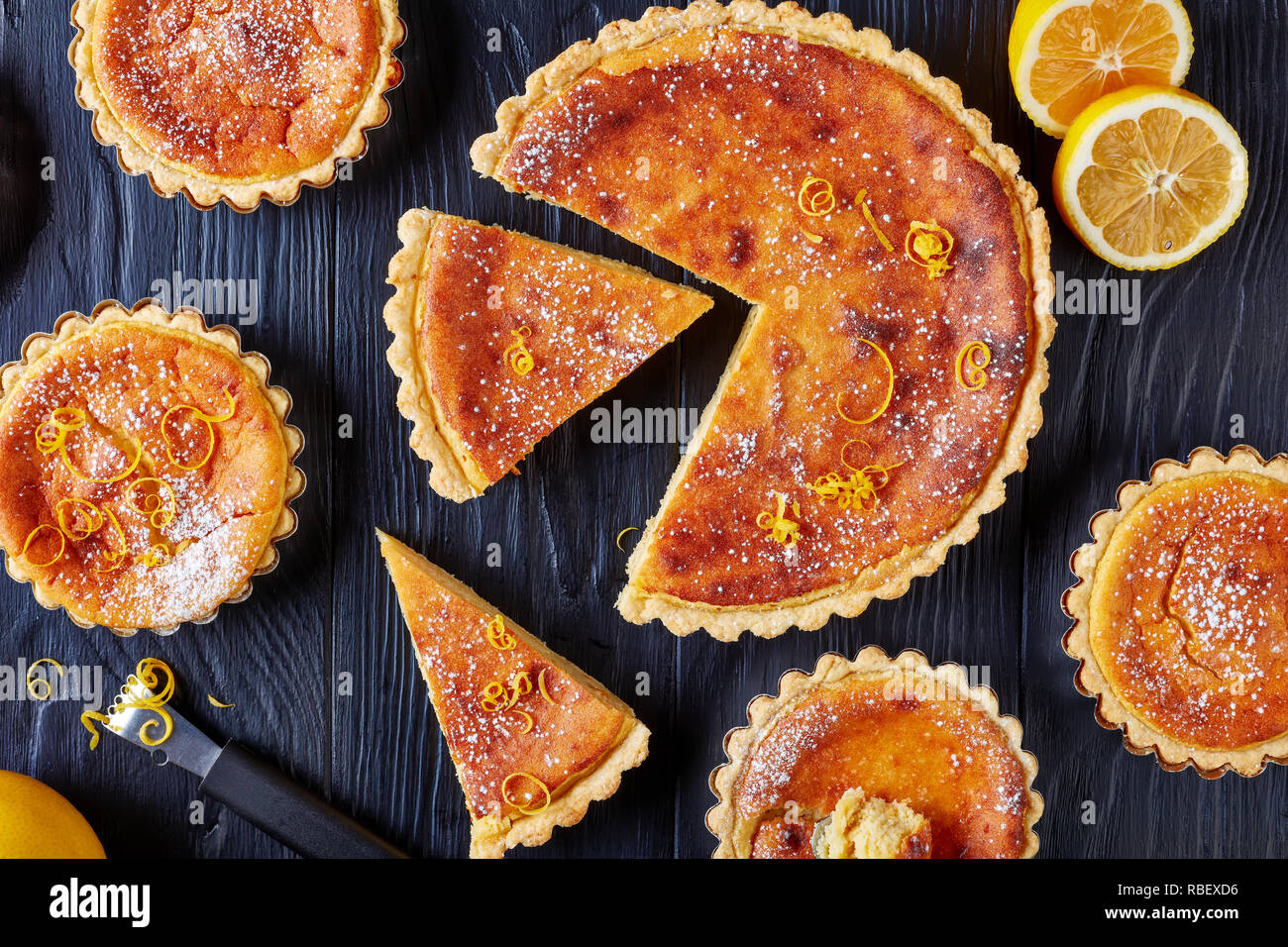 Traditional Swiss Easter Dessert Rice Tarts Sprinkled With Powdered Sugar And Lemon Zest Gateau De Paques Osterfladen On A Black Table With Lemon Stock Photo Alamy