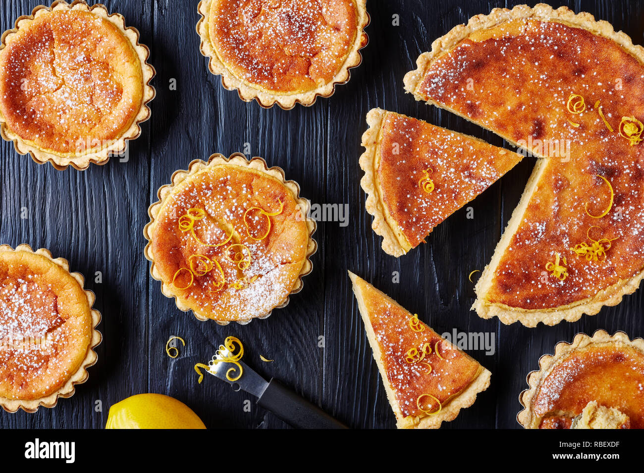 Swiss Easter Dessert Semolina Tarts Sprinkled With Powdered Sugar And Lemon Zest Gateau De Paques Osterfladen On A Black Table With Lemon Horizo Stock Photo Alamy