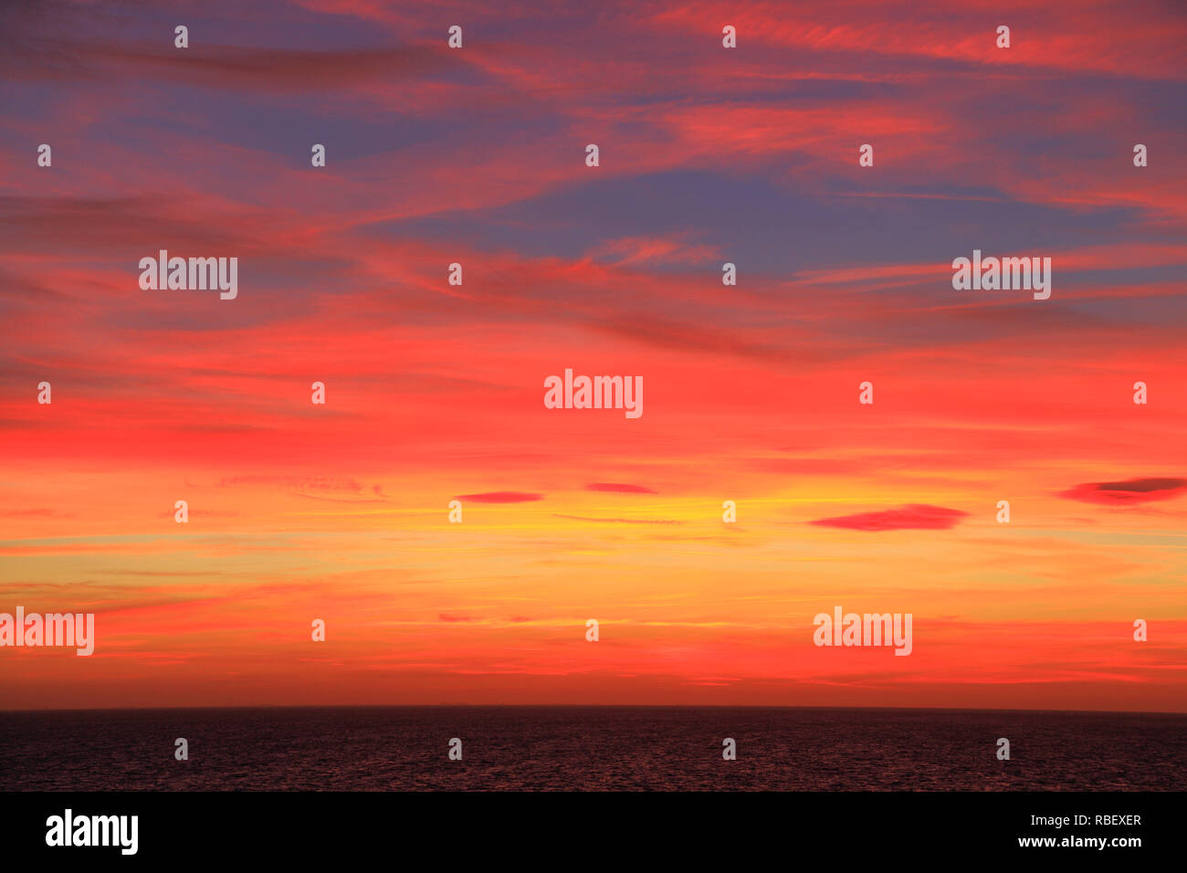 Red, orange, pink, blue, sky, after sunset, skies, cloud, clouds, formation, multi coloured, colours, colour, color, colors Stock Photo