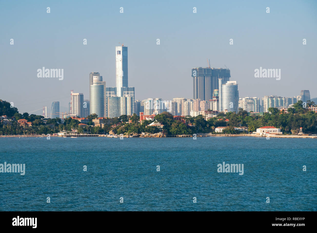 Modern buildings in skyline of Xiamen with Gulangyu island in foreground Stock Photo