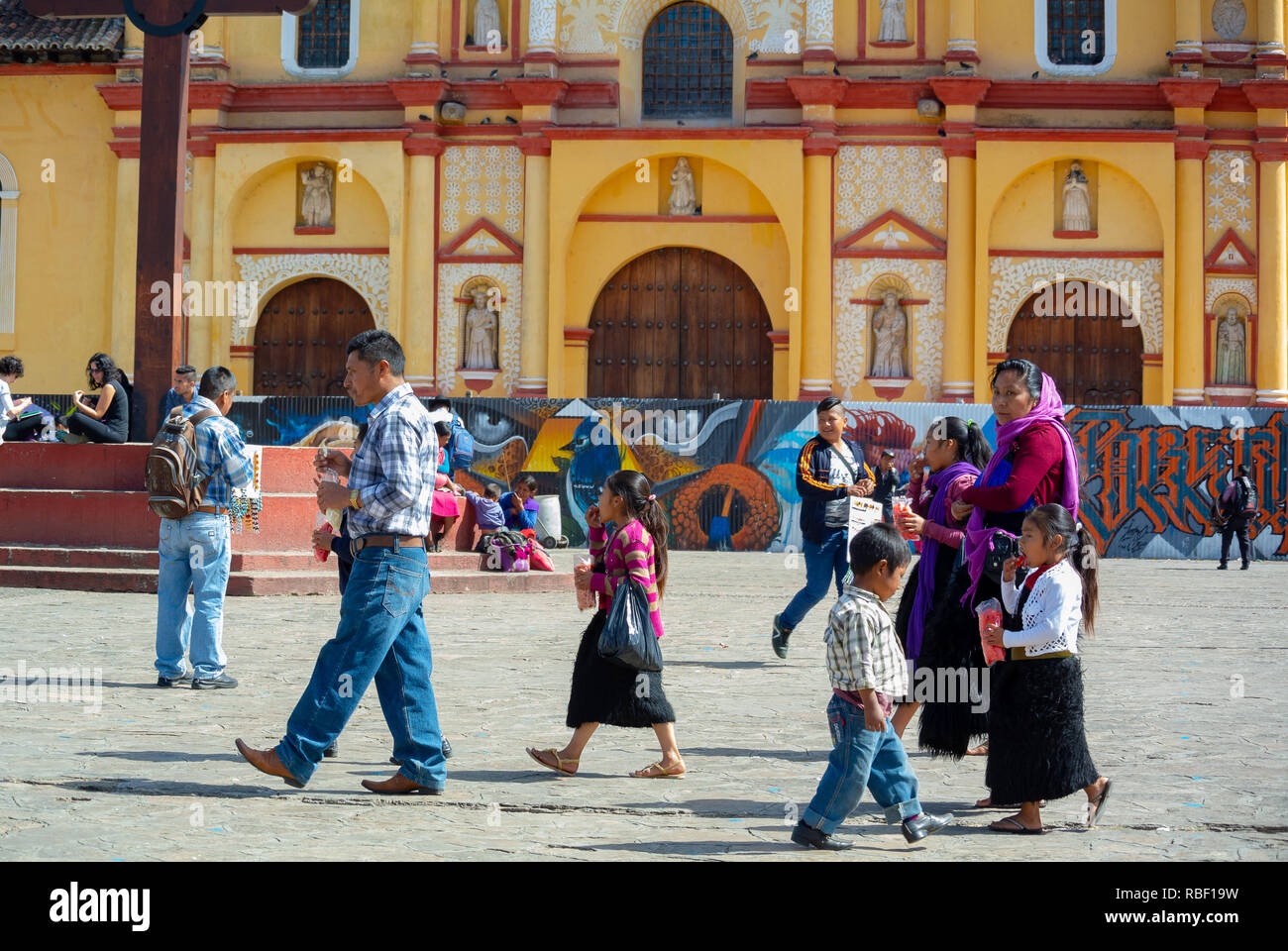 Local family walking at a square of cathedral, San Cristobal de las Casas, Chiapas, Mexico Stock Photo
