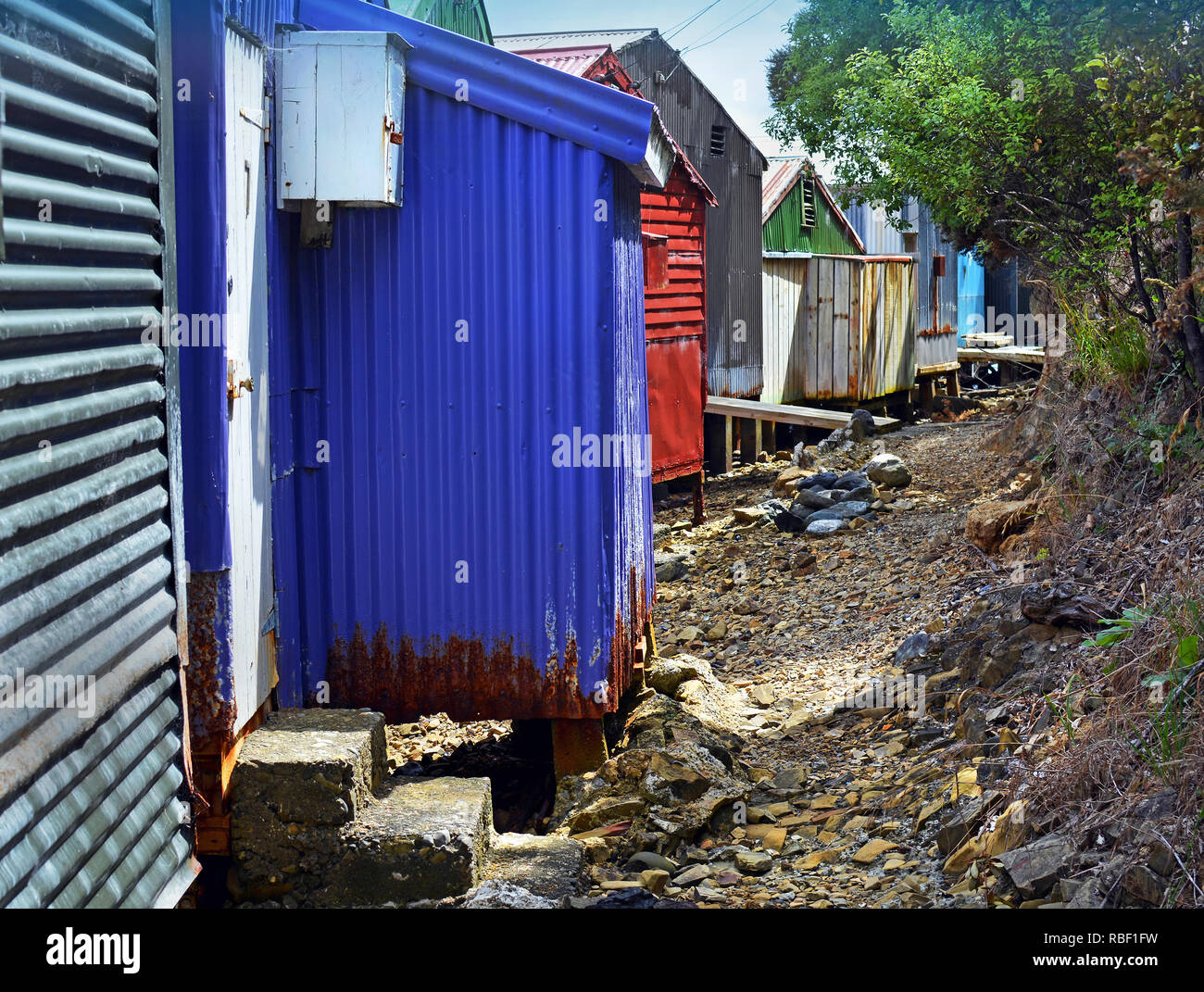 Multi-coloured corrugated iron boat sheds at Waikawa Bay, Picton, New Zealand Stock Photo