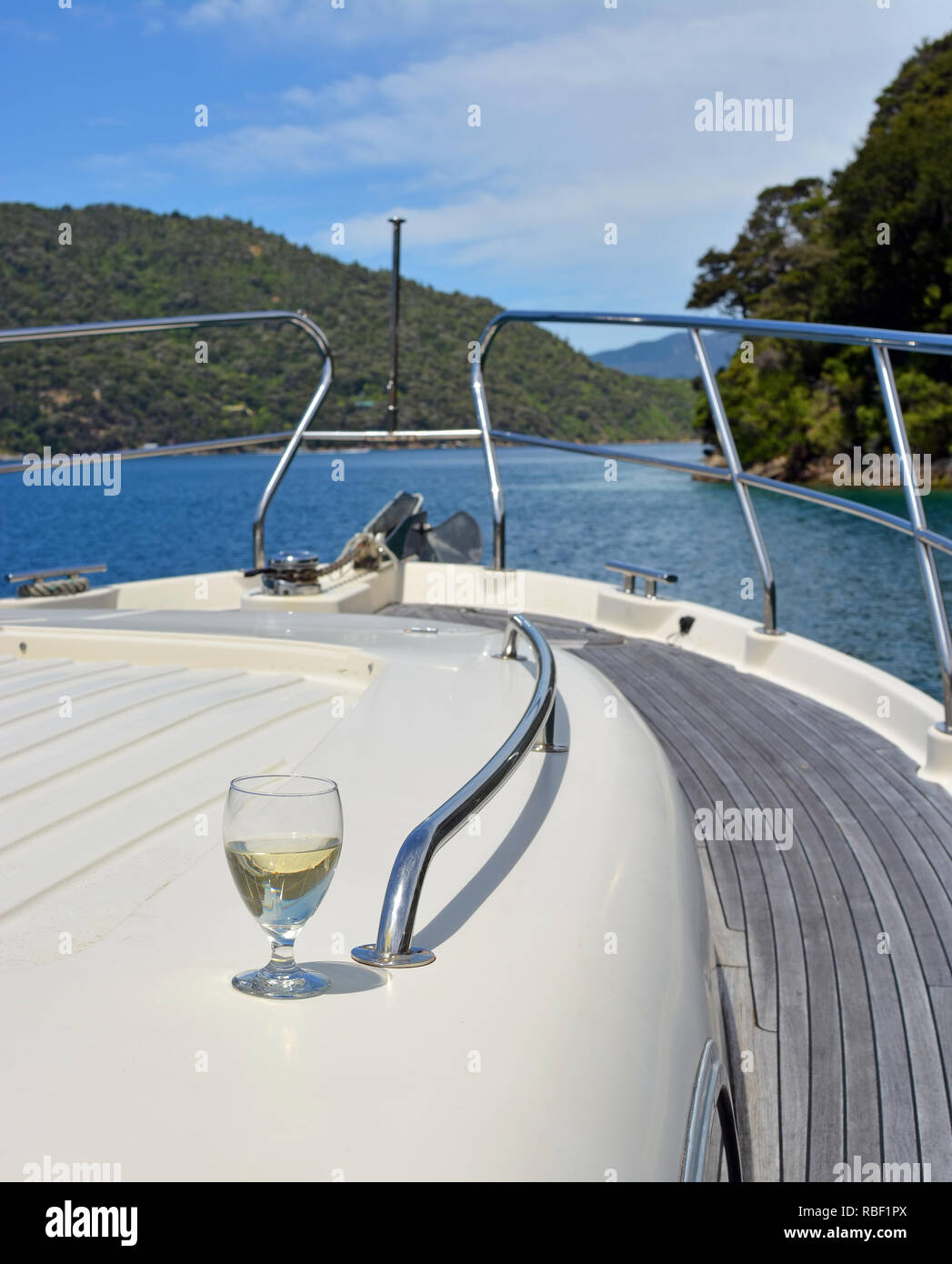 A Glass of Sauvignon Blanc Wine on the deck of a Luxury Motor Boat in the Marlborough Sounds New Zealand. Stock Photo