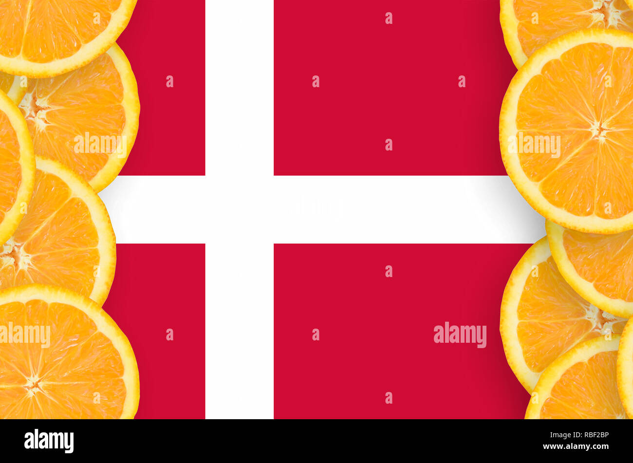 Denmark flag in vertical frame of orange citrus fruit slices. Concept