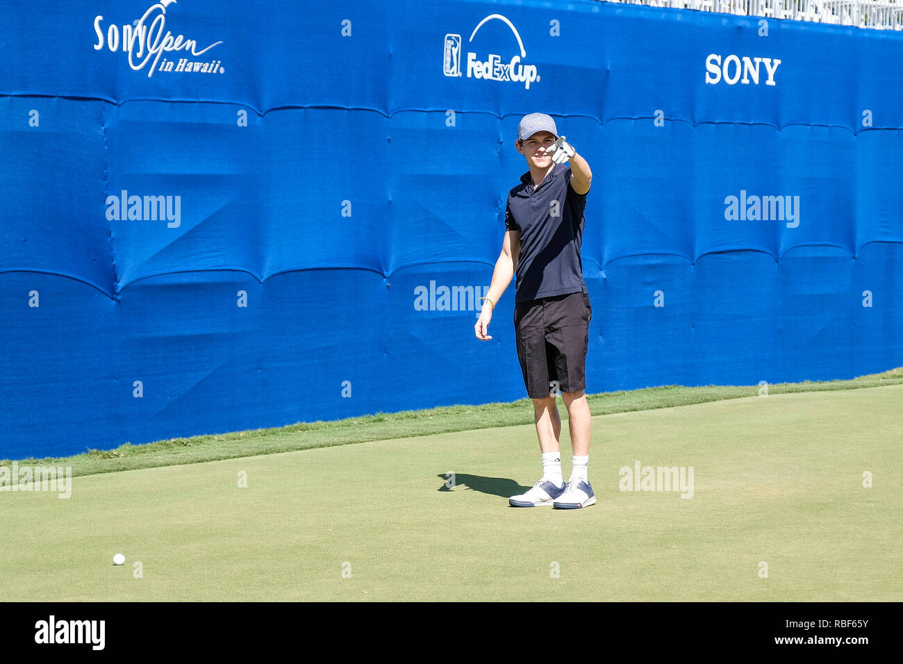 Honolulu, Hawaii, USA. 9th Jan, 2019. Tom Holland who plays the role of Spider Man in the Avengers movie points to fans on the 18th hole green during the Pro/Am day before the Sony Open at Waialae Country Club in Honolulu, Hawaii. Glenn Yoza/CSM/Alamy Live News Stock Photo