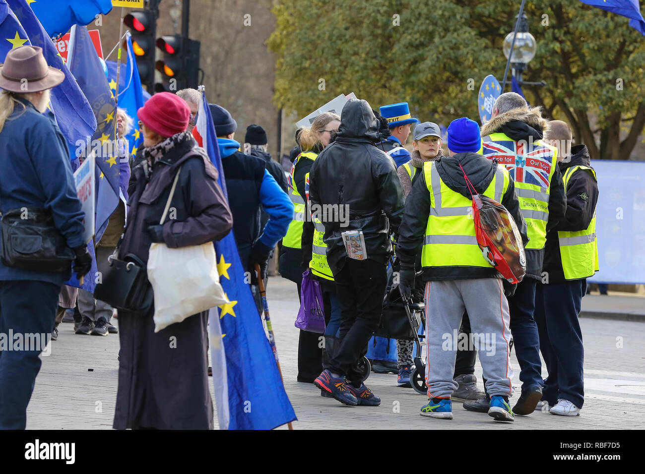 Yellow vest protesters are seen outside House of Parliament during the protest. Pro and anti- Brexit demonstrators gather outside the Houses of Parliament as the Meaningful Vote debate begins in Houses of Commons, at the end of the five day debate the MPs will vote on Prime Minister, Theresa May's Brexit deal. Stock Photo
