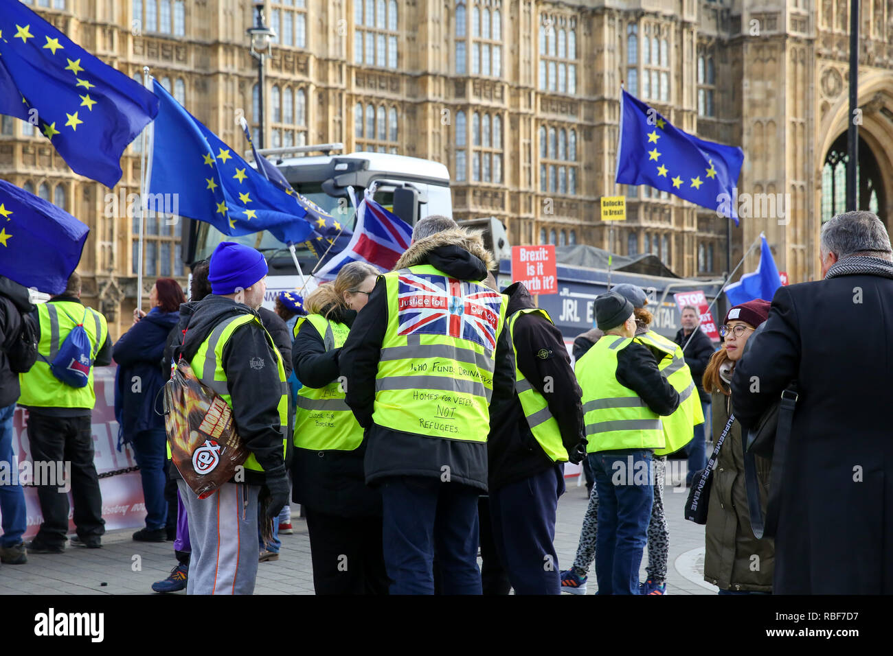 Yellow vest protesters are seen outside House of Parliament during the protest. Pro and anti- Brexit demonstrators gather outside the Houses of Parliament as the Meaningful Vote debate begins in Houses of Commons, at the end of the five day debate the MPs will vote on Prime Minister, Theresa May's Brexit deal. Stock Photo