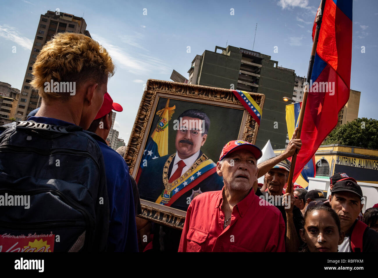 Caracas, Venezuela. 10th Jan, 2019. Supporters of the current Venezuelan government hold a portrait of President Maduro at a rally to support him. Maduro was sworn in for his second term. Numerous states, international organizations and the Venezuelan opposition spoke of an undemocratic electoral process and did not recognize the result of the last election. Credit: Rayner Pena/dpa/Alamy Live News Stock Photo