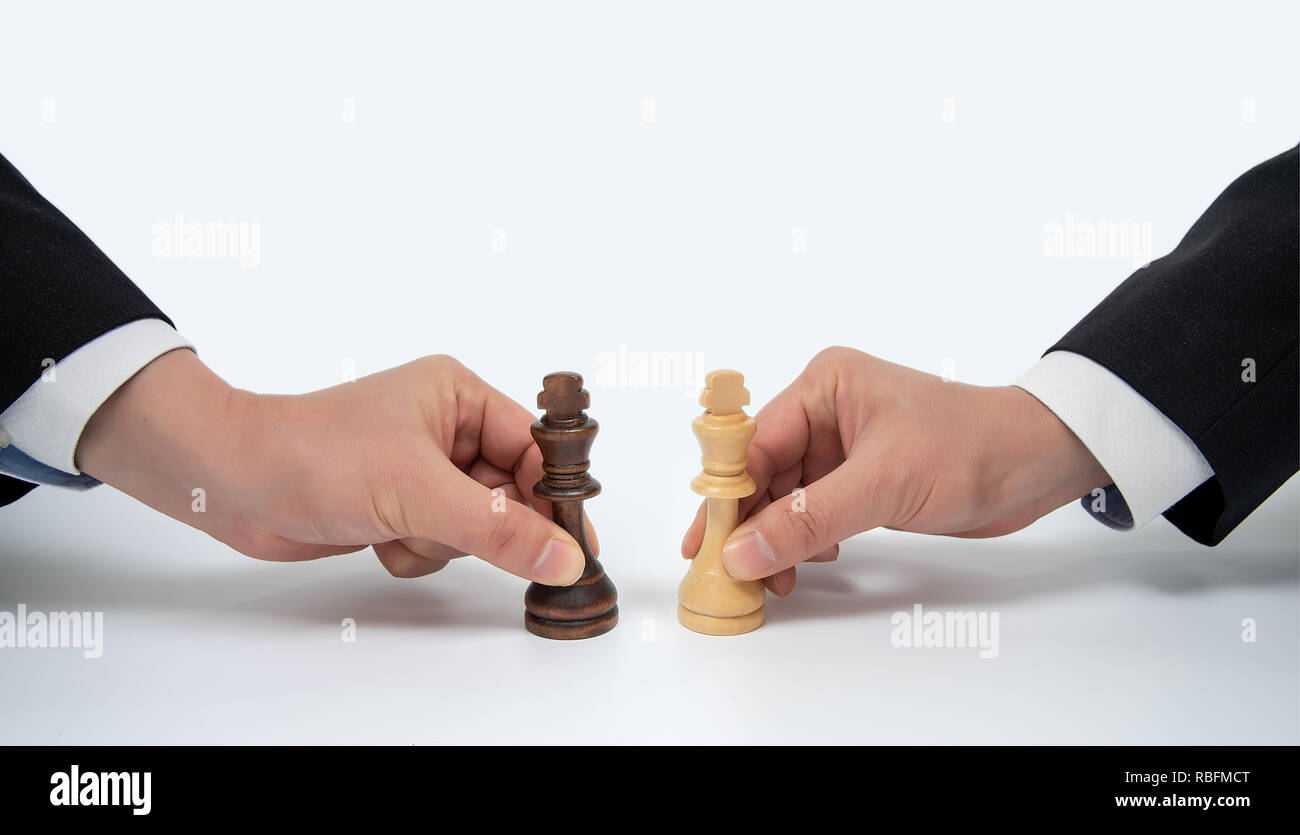 A skilled hand deftly slides a chess piece marked Chess across