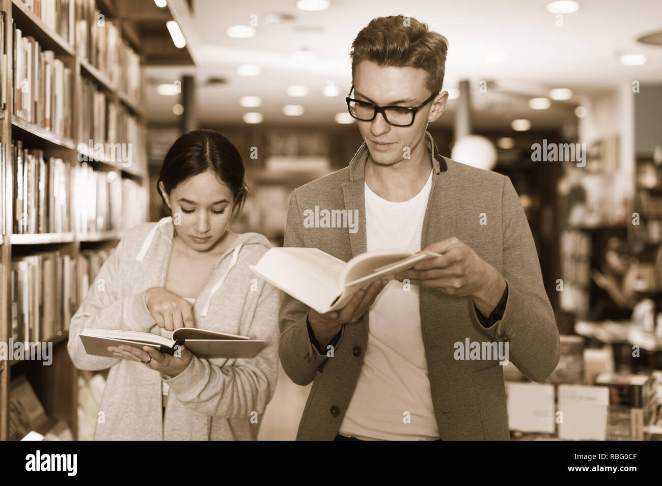 Young people spending time together reading books in library Stock ...