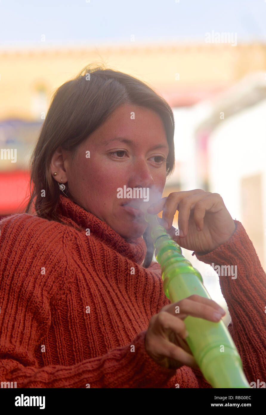 Female tourist smoking shisha pipe, Dahab, Egypt Stock Photo