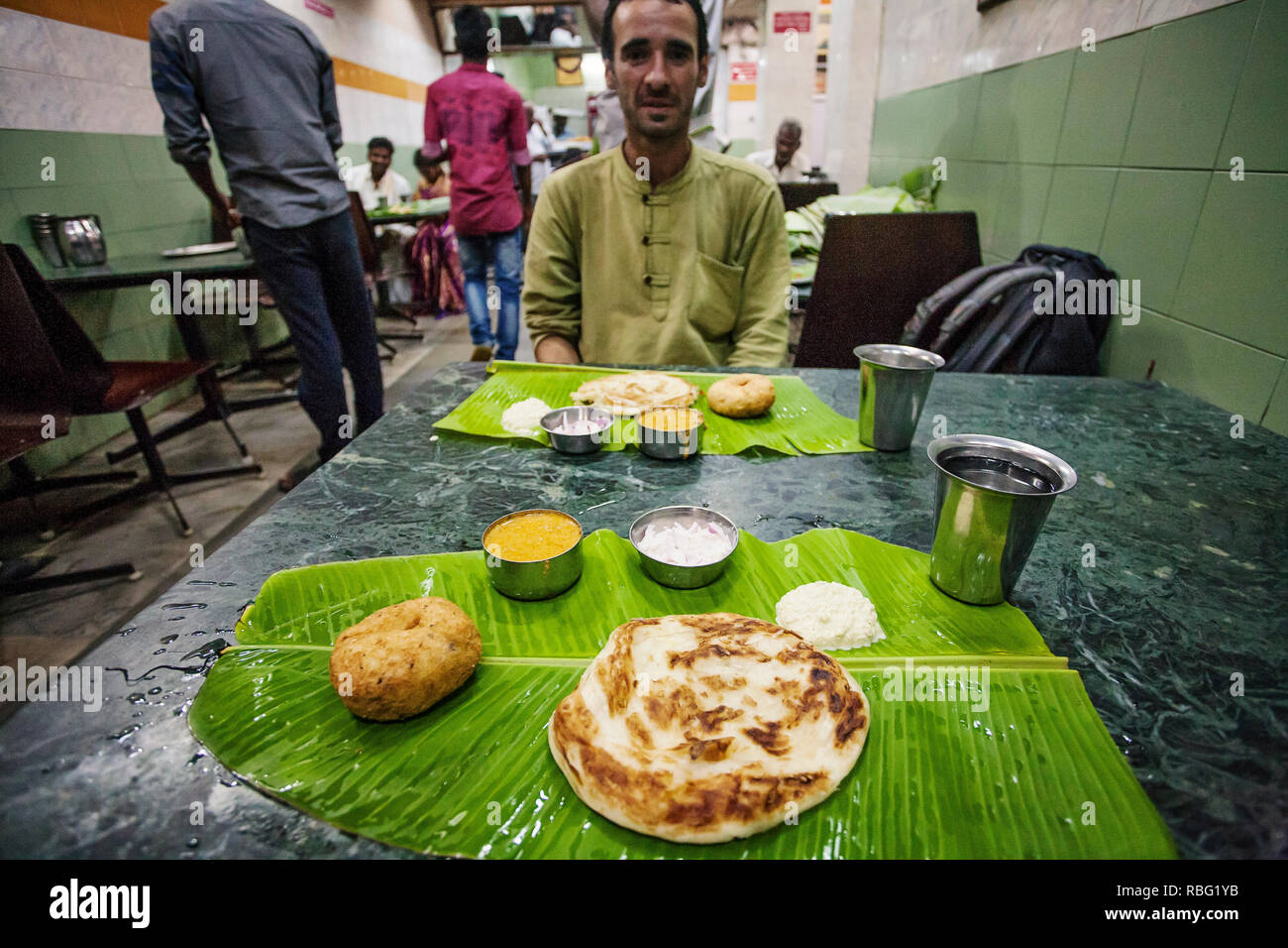 Tiruvannamalai, Tamil Nadu, India, January 29, 2018: Traditional Indian lunch food served on green coconut leaf Stock Photo
