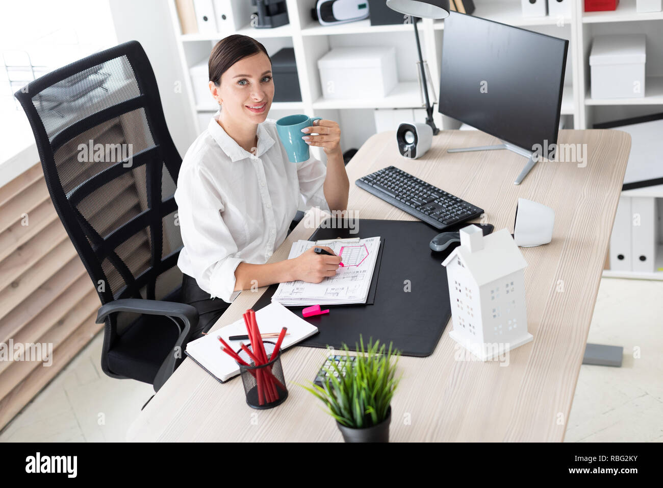 A young girl working in the office at the computer Stock Photo - Alamy