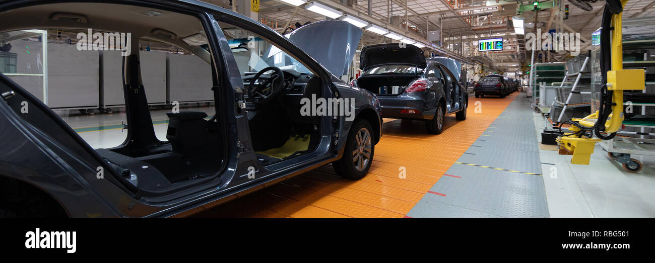Car without doors on production line. Long format. Wide angle view of plant of the automotive industry. Can be used as a banner Stock Photo